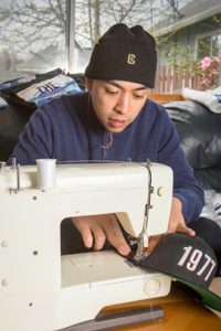 man sewing o sewing machine