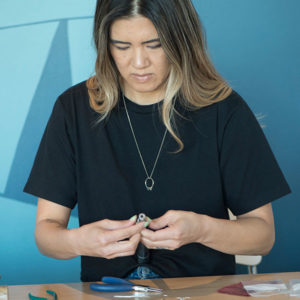 artist making jewelry